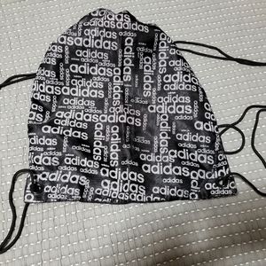 Adidas, reversible draw cord backpack.